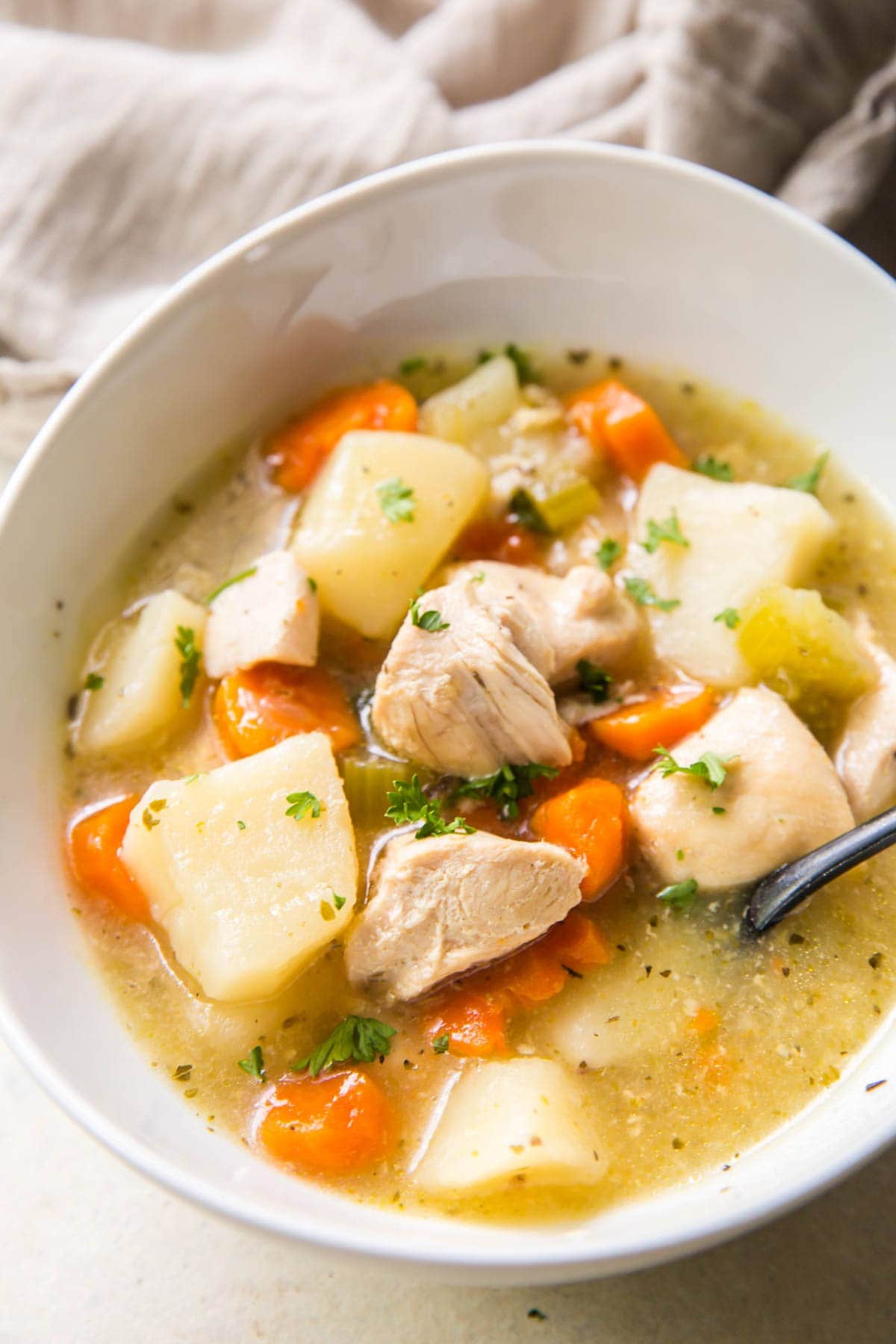 chicken stew in a white bowl on a table