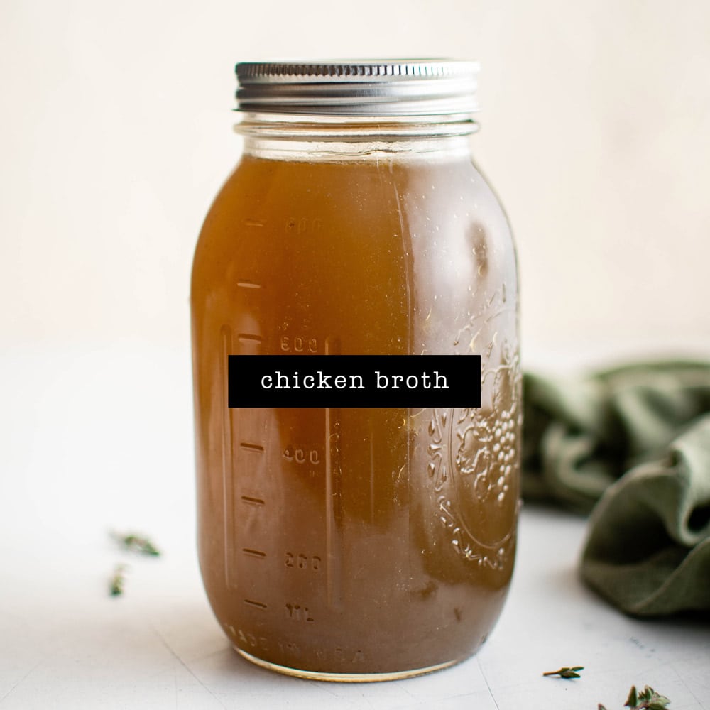 Homemade chicken broth in a glass jar.