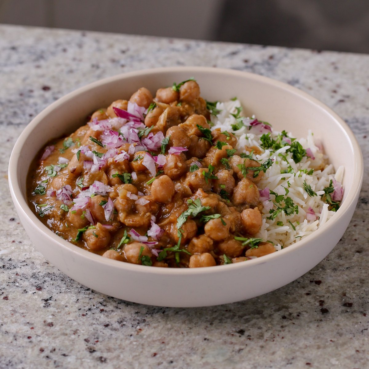 Punjabi chole in a bowl with rice and cilantro